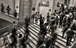 Black and white timelapse image of people walking on stairs