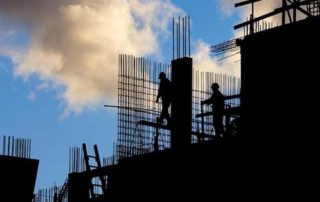 Construction workers in sillouhette during a building constrution