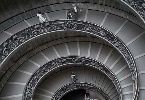 Downward perspective view of spiraling staircase